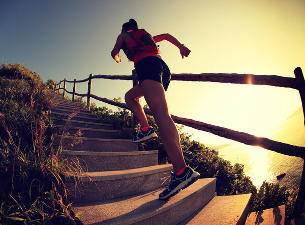 Fitness woman running up stairs