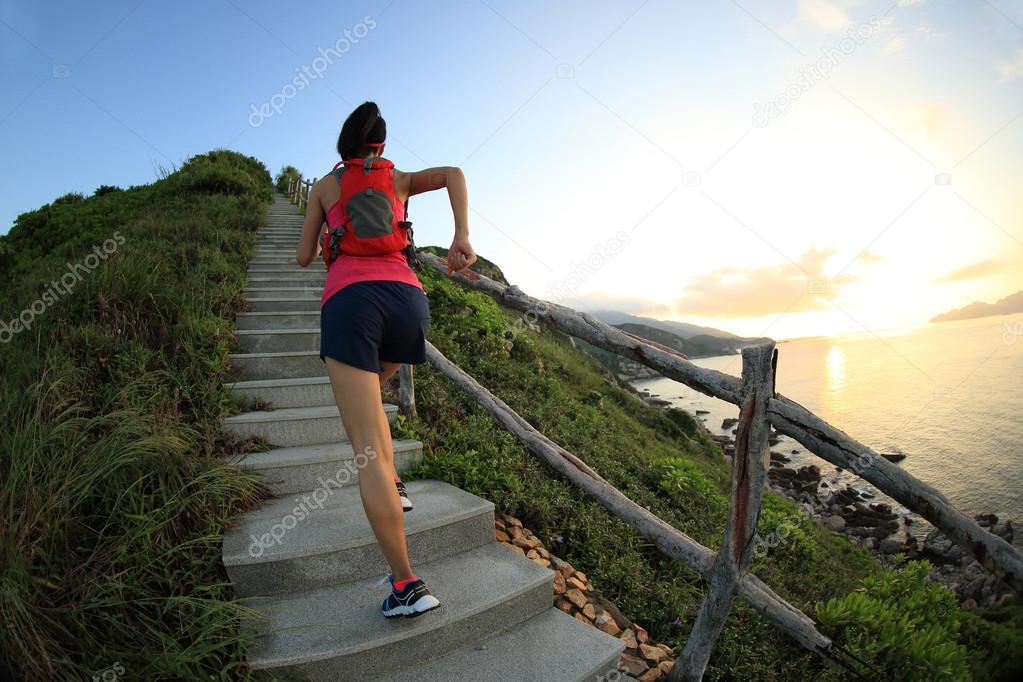 Fitness woman running up stairs
