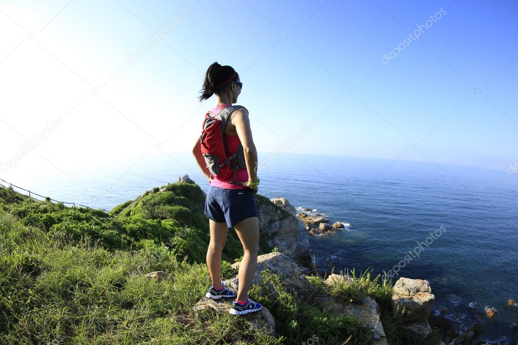 Young woman hiker on mountain peak