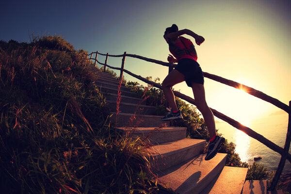 Fitness woman running up stairs