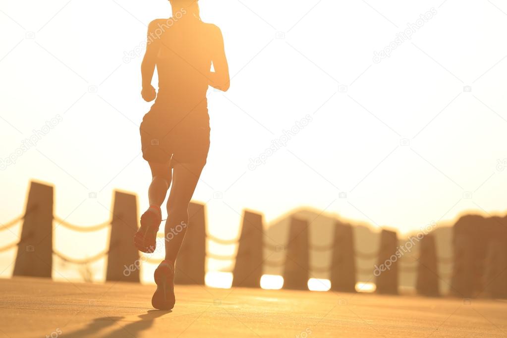 fitness woman running on seaside trail