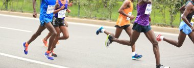 Marathon runners running on city road clipart