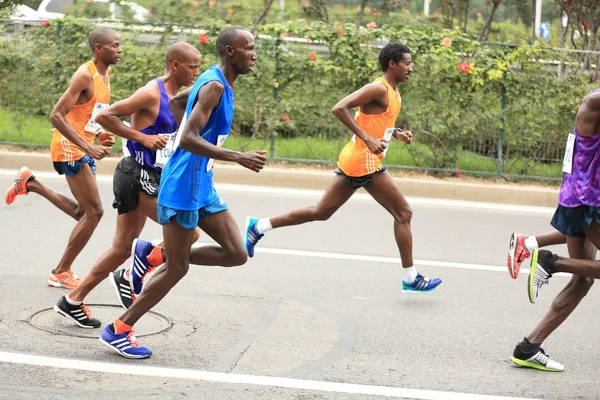 Marathon runners running on city road — Stock Photo, Image