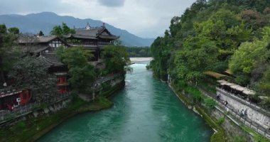 Vibrant turquoise river flowing through lush, green gorge.