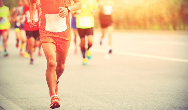 marathon runners on city road