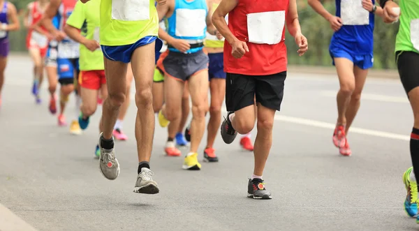 marathon runners on city road