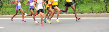 marathon runners on city road clipart