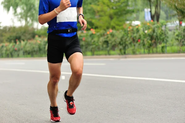 Marathon runner on city road