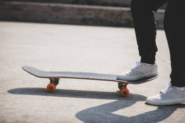 cropped shot of skateboarder skateboarding at skatepark in city