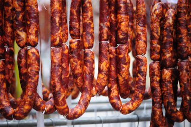 Hanging sausages in row at market