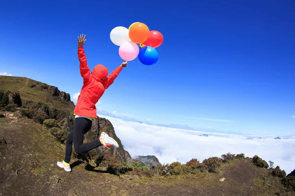 Juichende jonge vrouw kleurrijke ballonnen — Stockfoto