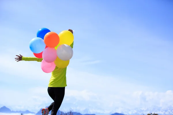 Young woman with colorful balloons — Stock Photo, Image