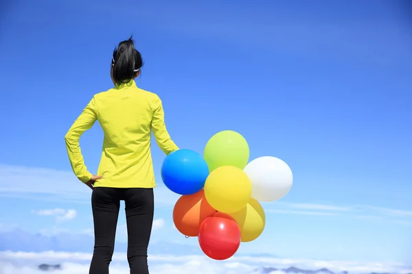 Cheering woman with colorful balloons — Stock Photo, Image