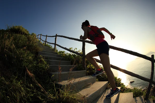 Fitness woman running up stairs — Stock Photo, Image