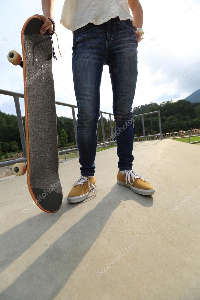 skateboarder with skateboard at park