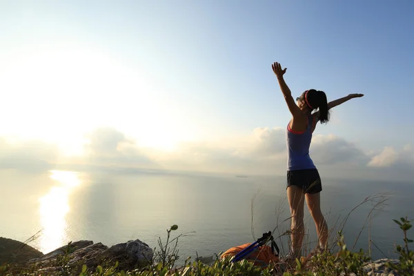 Torcendo mulher caminhante no pico da montanha — Fotografia de Stock