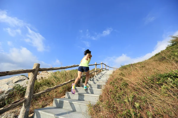 Woman running up on stone stairs — Stock Photo, Image