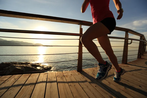 Fitness mujer corriendo a la orilla del mar — Foto de Stock