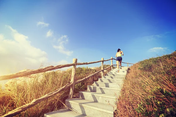 Woman running up on stone stairs — Stock Photo, Image