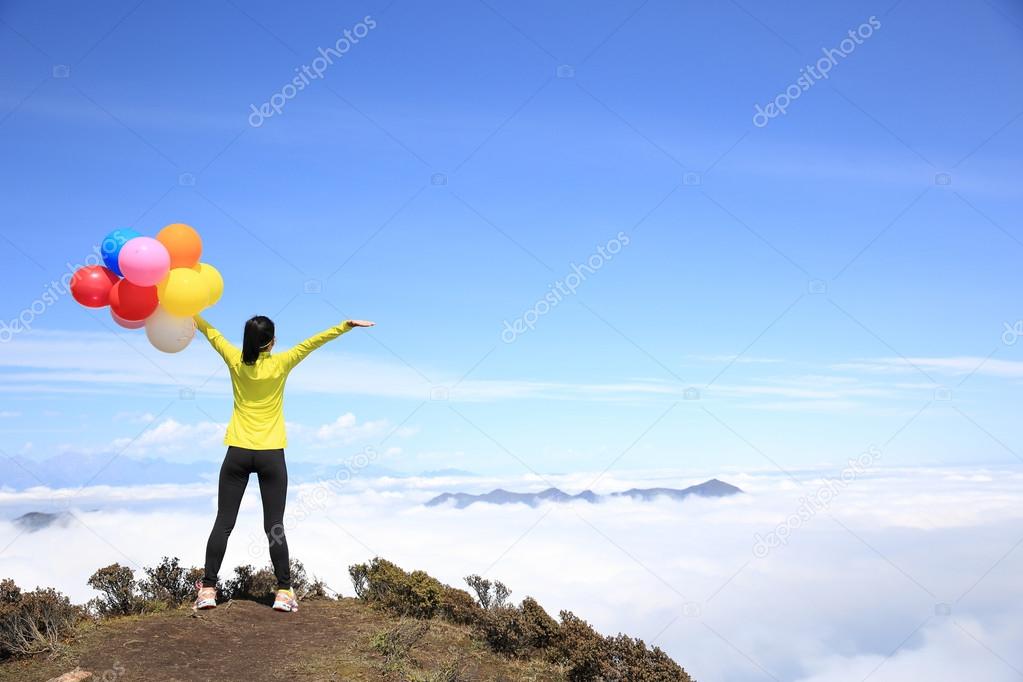 young woman with colorful balloons