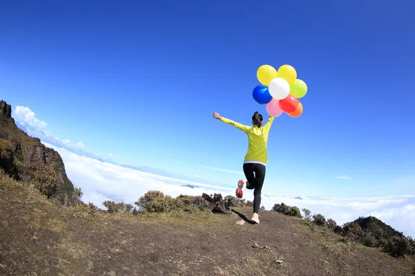 Cheering woman with colorful balloons