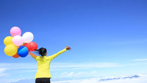 Jubelnde Frau mit bunten Luftballons — Stockfoto