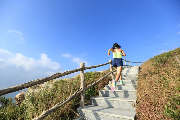 Fitness woman running up stairs — Stock Photo, Image