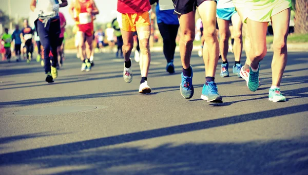 Marathon athletes running on road — Stock Photo, Image