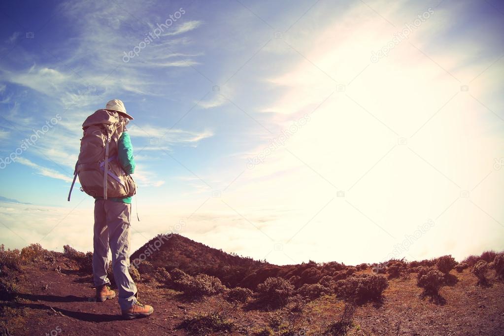 woman backpacker on mountain peak