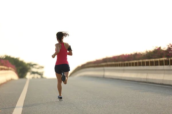 Woman runner on road — Stock Photo, Image