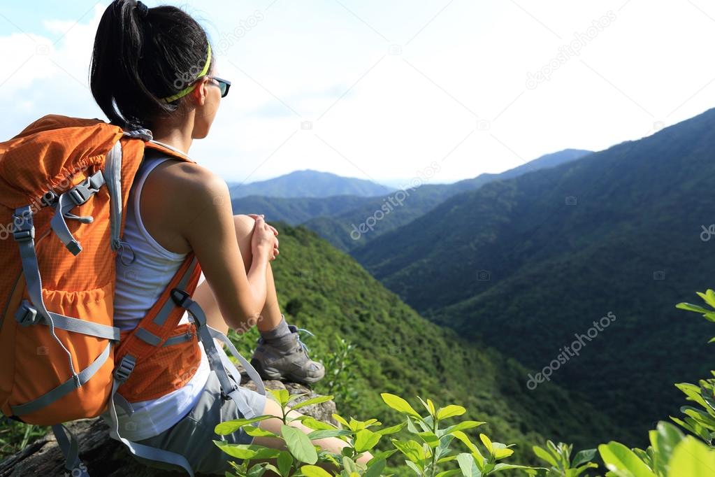 young woman backpacker at mountain