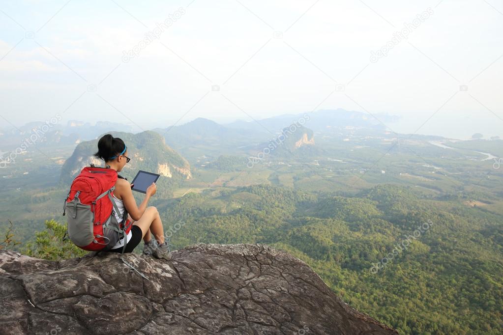 woman hiker use digital tablet