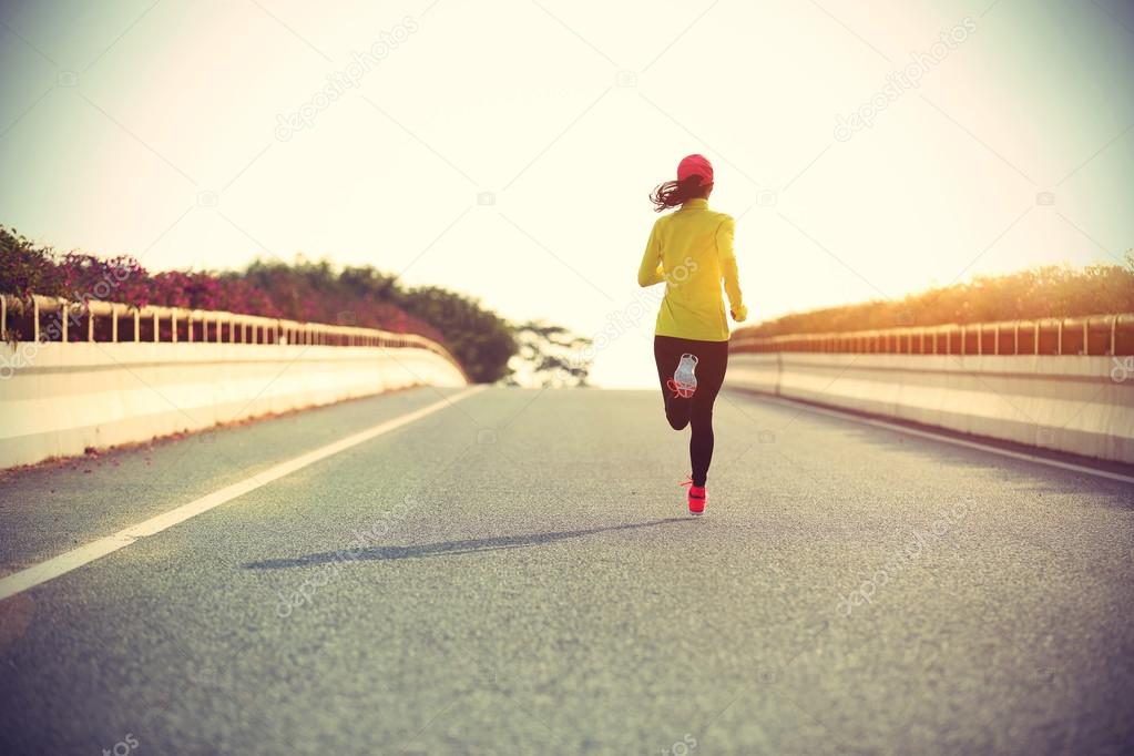 sporty woman runner on road