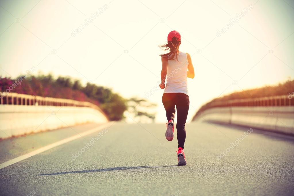 sporty woman runner on road