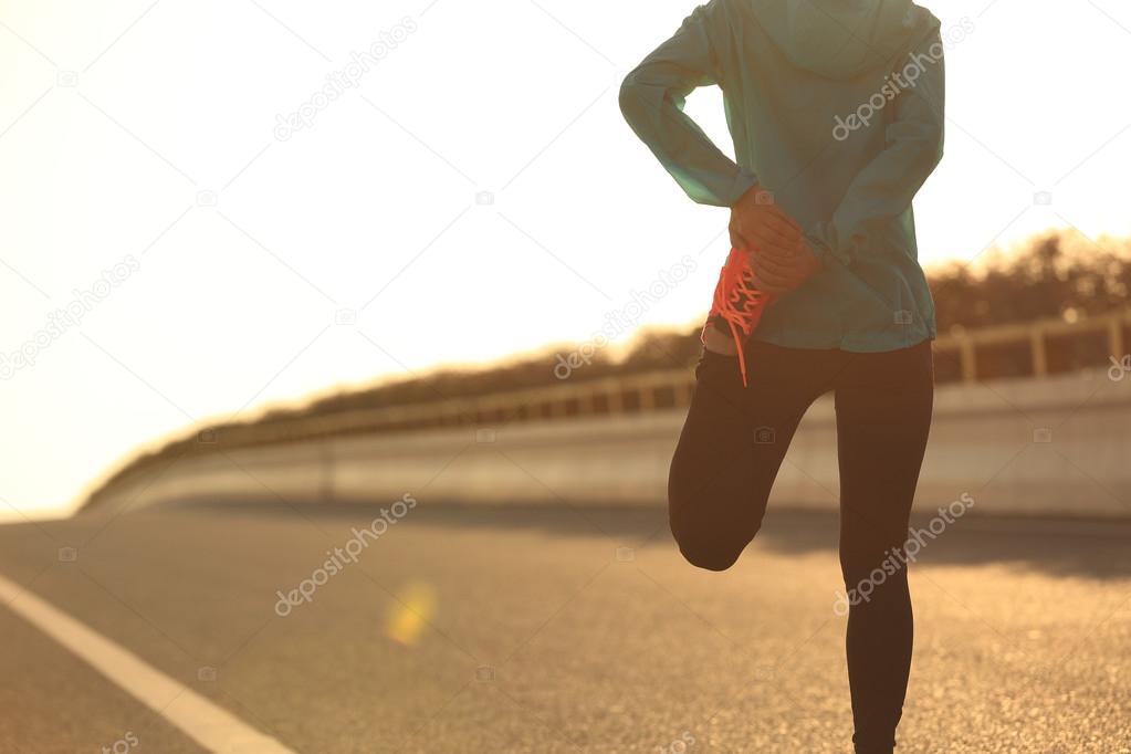 fitness woman runner stretching leg