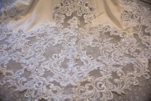 Close up of beautiful lace detail on a wedding dress train — Stock Photo, Image