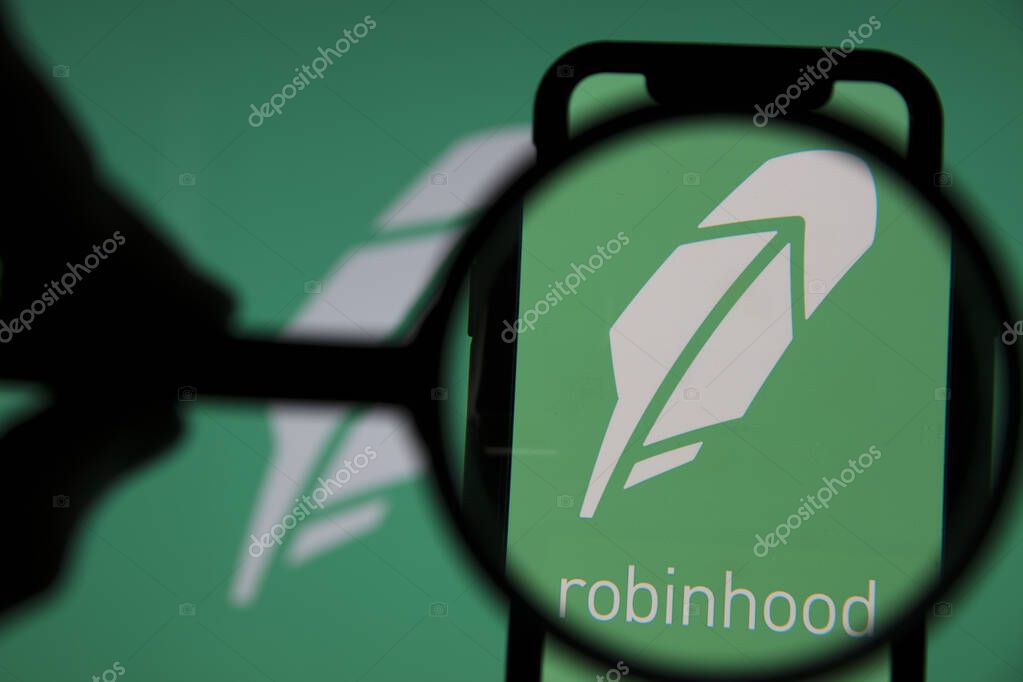 LONDON, UK - January 2021: Robinhood investing app under magnifying glass.