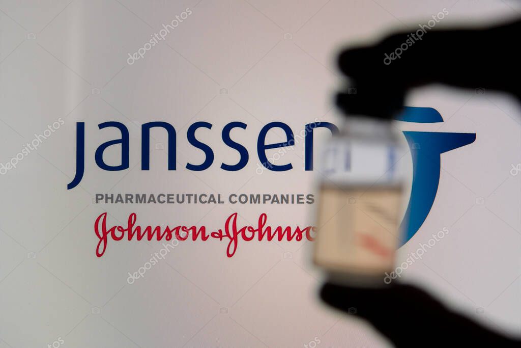 OXFORD, UK - February 2020: A covid vaccine vial against the Janssen logo.