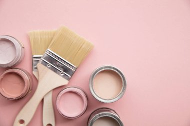 Overhead view of a DIY paint brush with pastel pink sample paint pots clipart