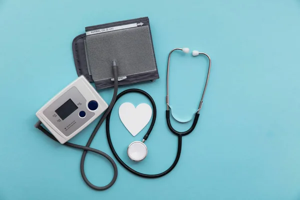 Blood pressure test monitor with a stethoscope on a blue background — Stock Photo, Image