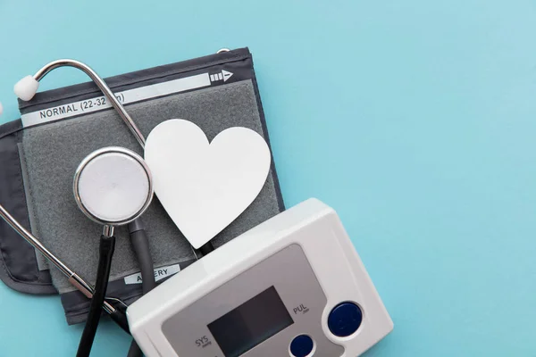 Monitor de presión arterial con estetoscopio sobre fondo azul — Foto de Stock