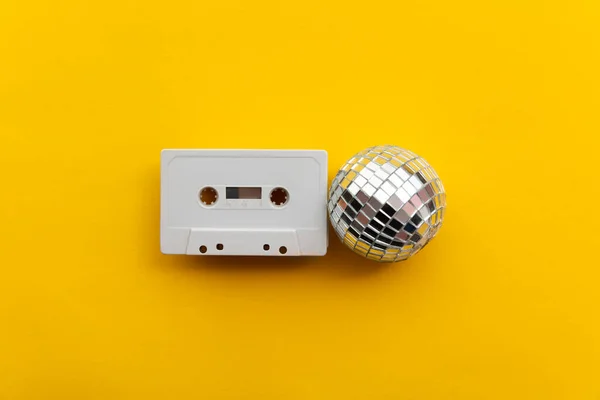 Retro disco glitter ball with a vintage cassette tape — Stock Photo, Image