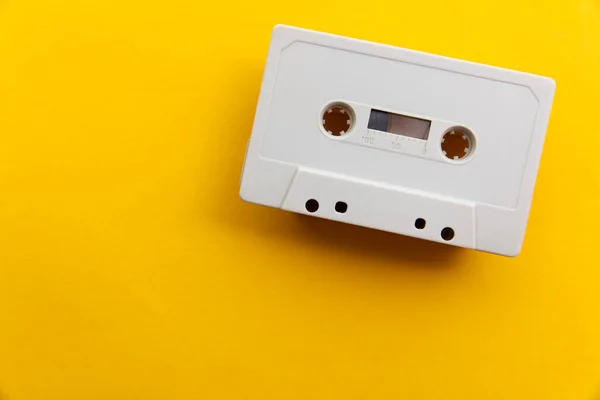Vintage white cassette tape on a bright yellow background — Stock Photo, Image