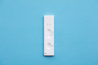 Mavi arka planda Coronavirus lateral akış ev test kiti