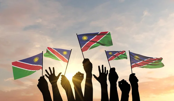 Silhueta de armas levantada acenando uma bandeira da Namíbia com orgulho. Renderização 3D — Fotografia de Stock