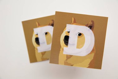 LONDON, UK - June 2021: Doge or dogecoin cryptocurrency logo on paper