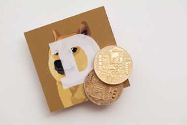 LONDON, UK - June 2021: Doge or dogecoin cryptocurrency logo on paper
