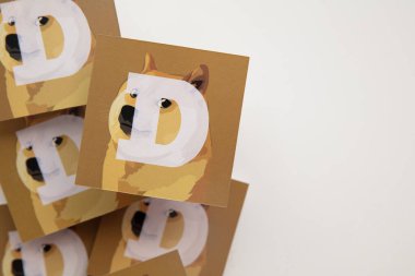 LONDON, UK - June 2021: Doge or dogecoin cryptocurrency logo on paper