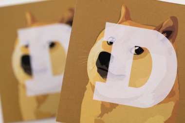 LONDON, UK - June 2021: Doge or dogecoin cryptocurrency logo on paper