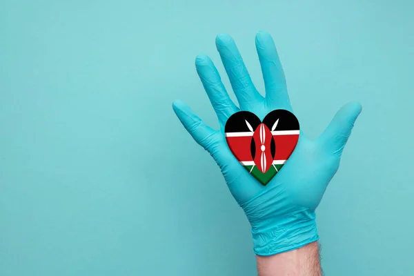 Kenya medical health heart. Nurse hand holding country heart flag